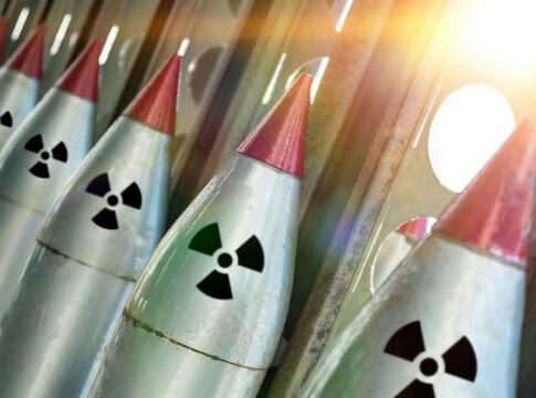 Nuclear missiles with radiation warning symbols lined up.