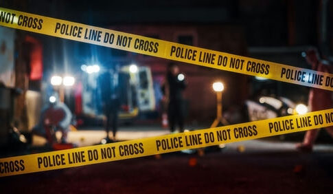 Yellow police tape at a nighttime crime scene.