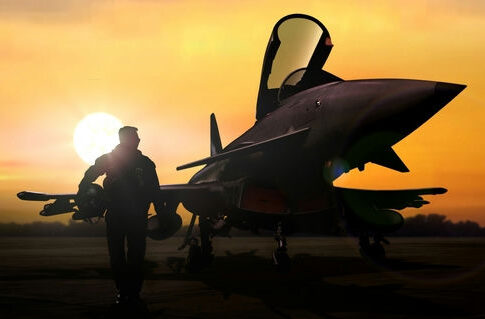 Fighter jet and pilot silhouetted at sunset on runway