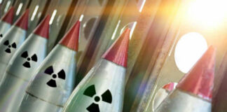 Nuclear missiles with radiation warning symbols lined up.