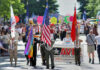 Parade with flags and AVER Puget Sound banner.
